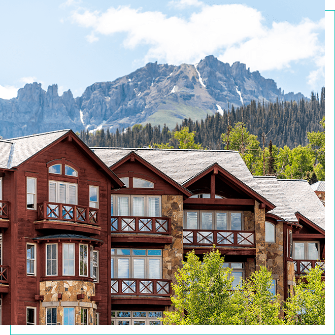 Luxurious Colorado Living: Modern Home with Mountain Views Home with mountains and pine trees in the background