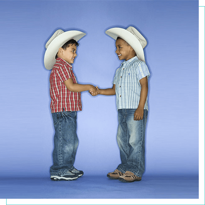 Community Friendship: Young Boys in Cowboy Hats Handshake - Ideal for Family-Friendly Neighborhoods Two young boys in cowboy hats shaking hands, symbolizing friendly neighborhood relations in family-oriented communities.